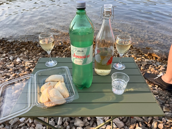 Wine and snacks on a flat seaside rock